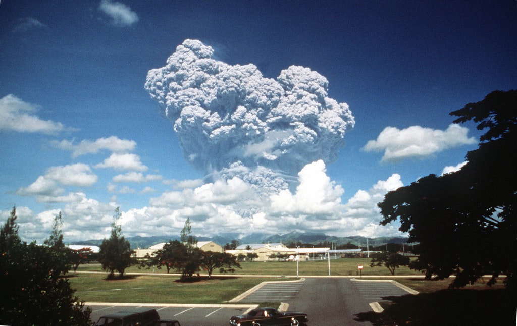 A large volcanic eruption cloud seen from distance.