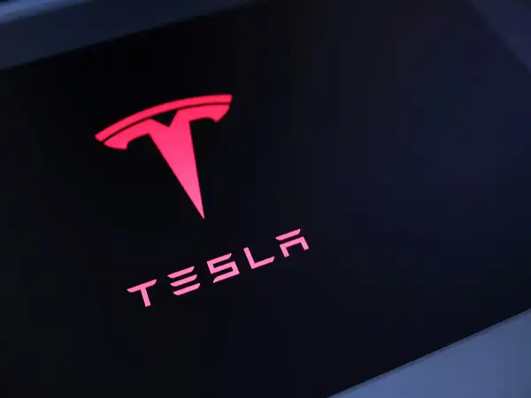 Tesla Reports Significant Earnings Decline as Elon Musk Cautions About Challenging Quarters Ahead